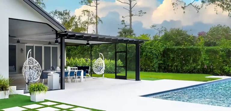 Modern Renaissance-style aluminum patio cover with screened sides over a poolside dining area.